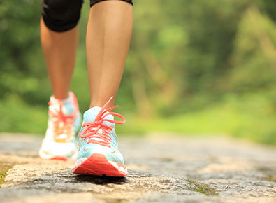 Close up of shoes walking on a road.